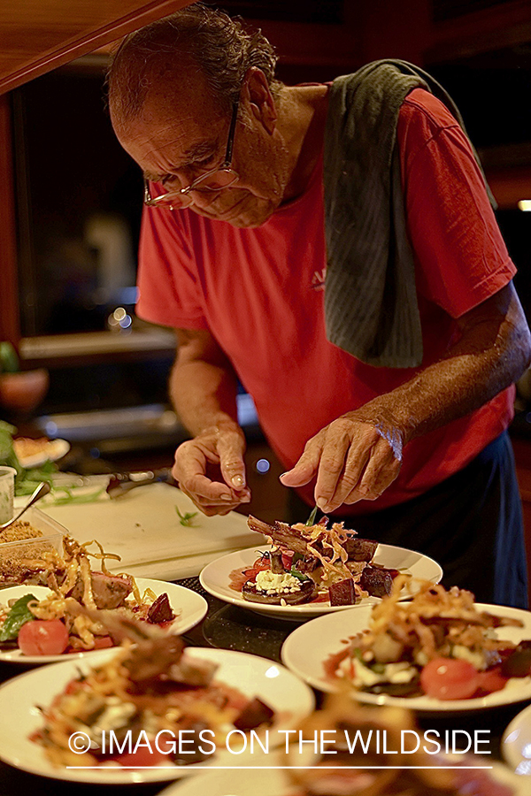 Chef preparing meal on liveaboard.