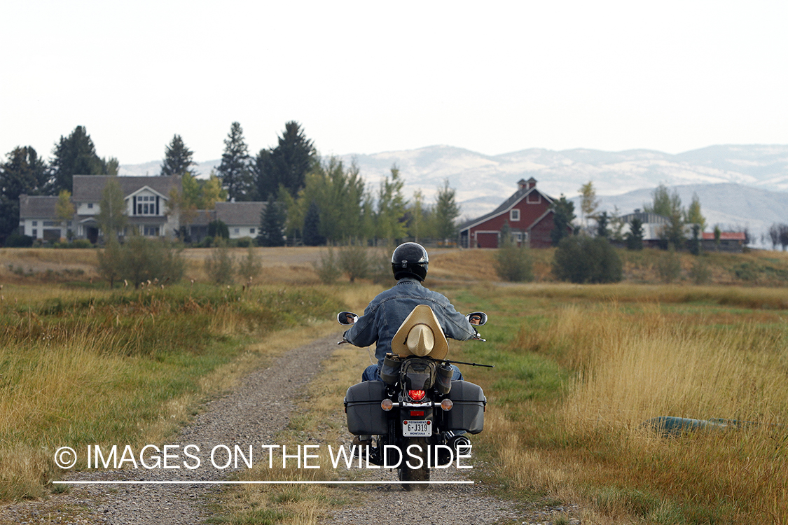 Flyfisherman on motorcyle.