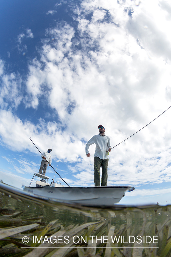 Flyfisherman on flats boat with guide.