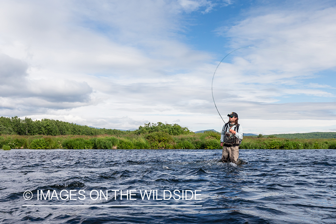 Flyfisherman casting on the Sedanka river in Kamchatka Peninsula, Russia.