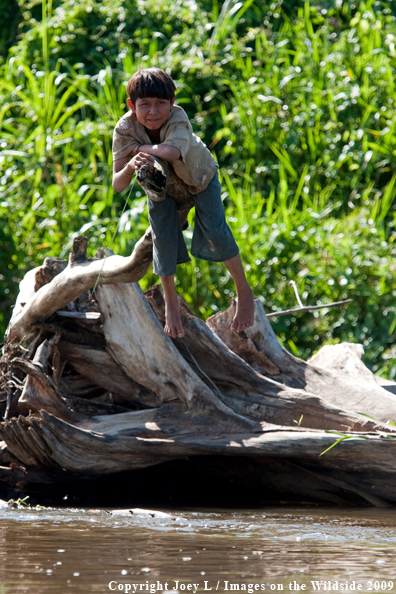 Young local Bolivia native along river edge