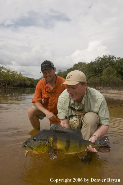 Fishermen holding Peacock Bass