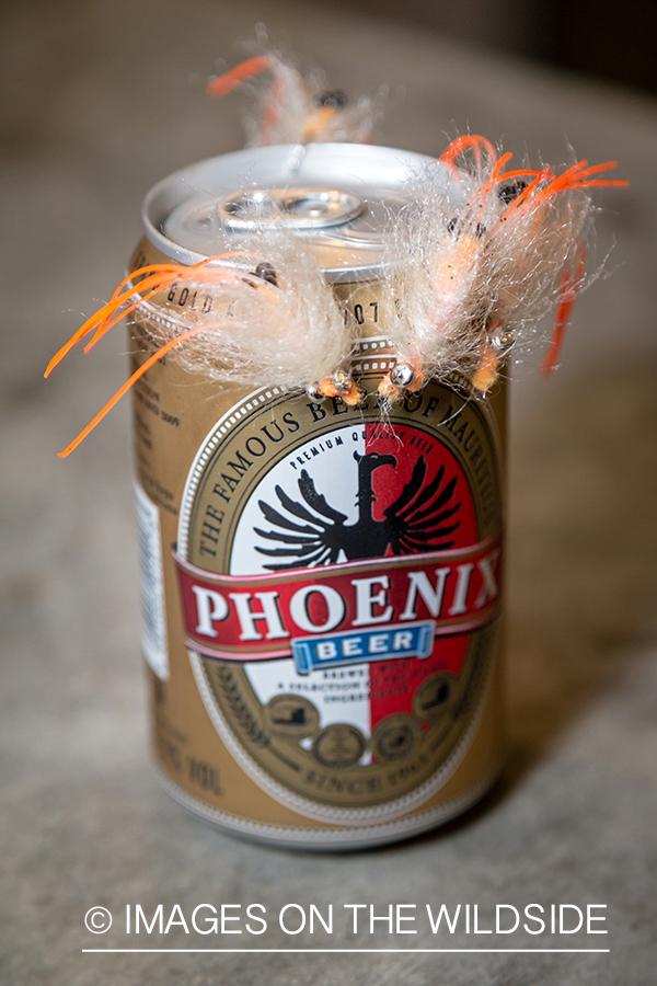 Saltwater flies on beer can.