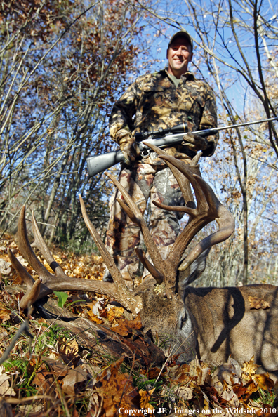 White-tail hunter with bagged buck. *