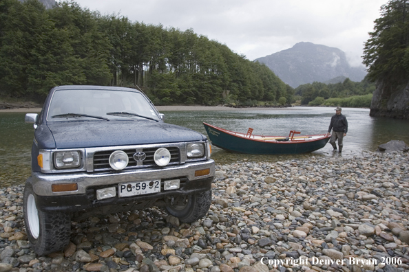 Flyfisherman loading/unloading driftboat.