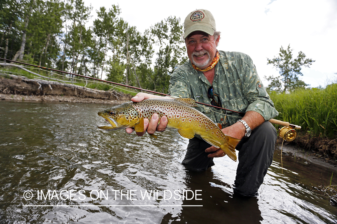 Flyfisherman with brown trout.