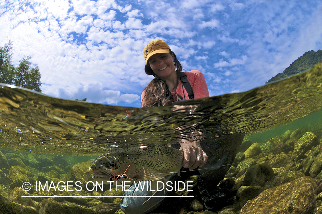 Flyfishing woman with rainbow trout.