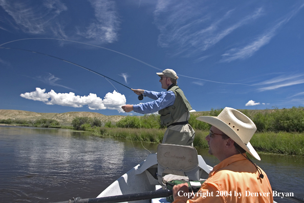 Flyfishermen casting from drift boat (MR).