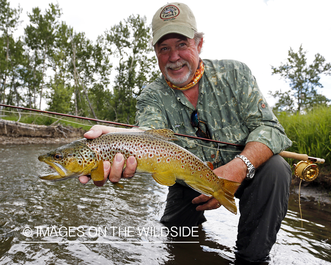 Flyfisherman with brown trout.