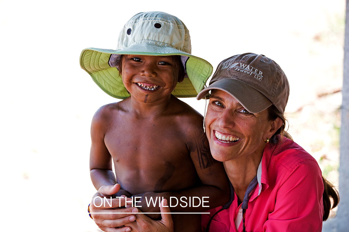 Woman flyfisherman with native child in Kendjam region, Brazil.