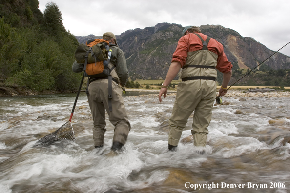 Flyfishermen walking up river.