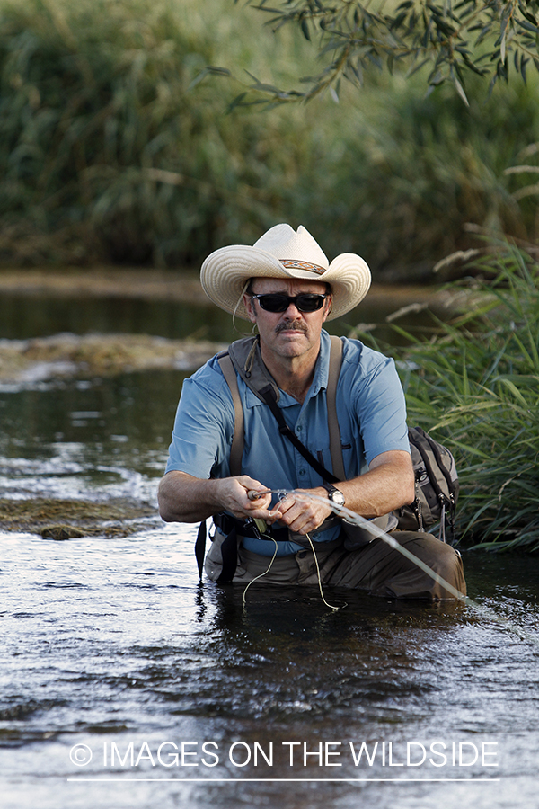 Flyfisherman fishing small stream.