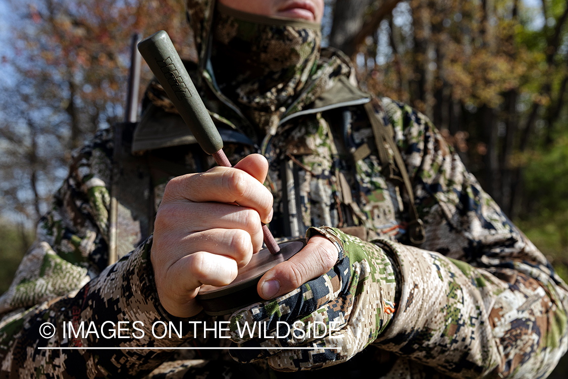 Hunter using turkey slate call.