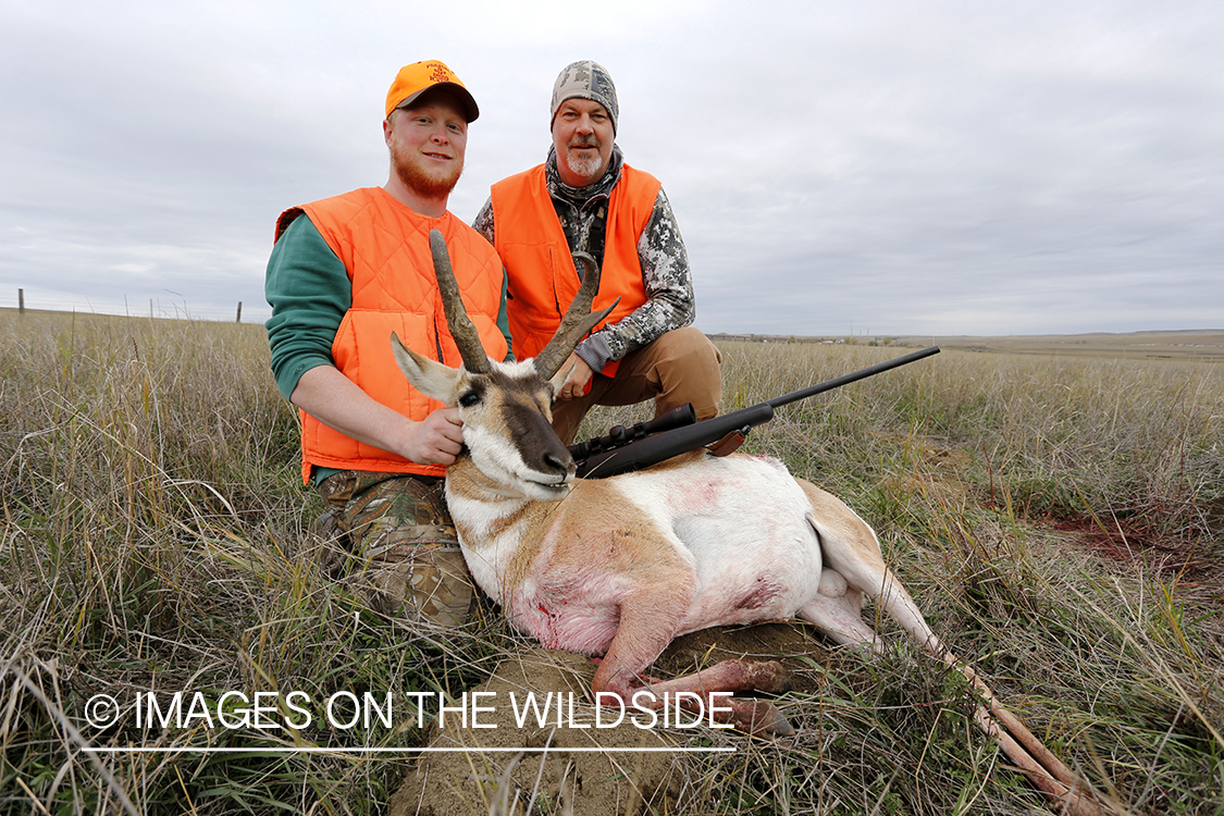 Hunters with pronghorn antelope buck.