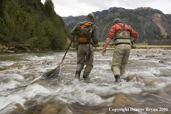 Flyfishermen walking up river.