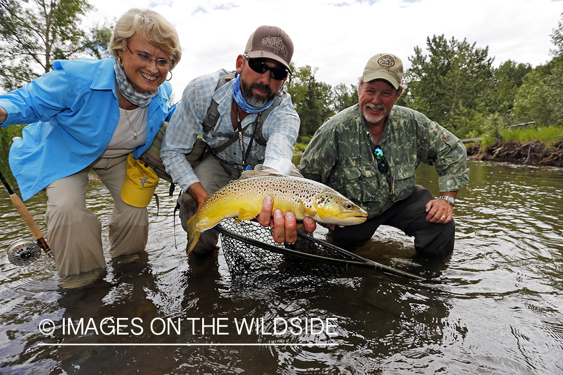 Flyfishing couple and guide with brown trout.