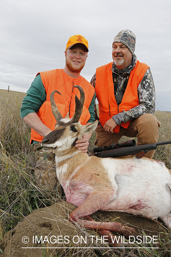 Hunters with pronghorn antelope buck.